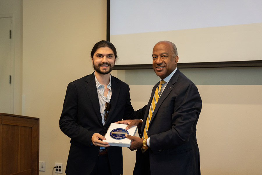 Chancellor Gary S. May presents someone with an award