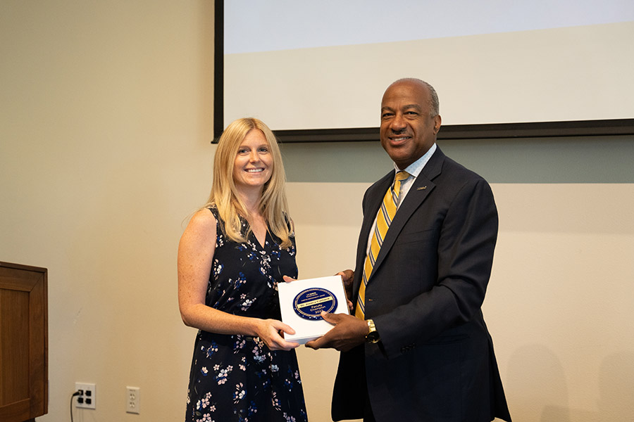 Chancellor Gary S. May presents someone with an award