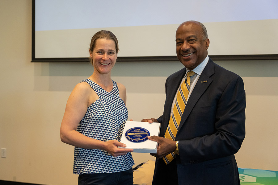 Chancellor Gary S. May presents someone with an award