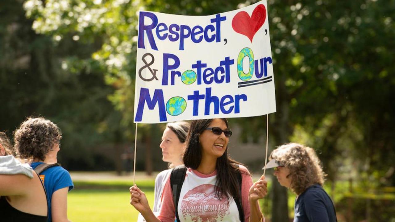 Global Climate Strike came to the Quad last September. (Gregory Urquiaga/UC Davis) Person holds a sign that reads "Respect & Protect Our Mother"