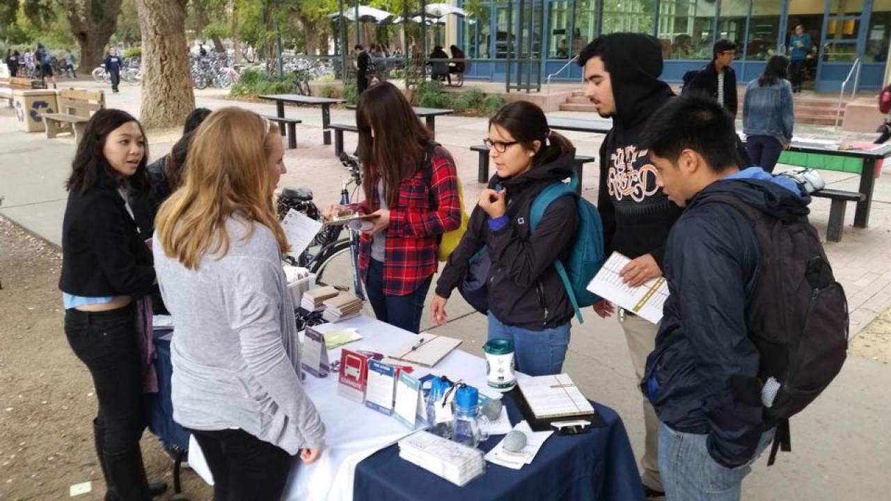 Tabling event outside the Memorial Union offers information on the Aggie Green Pledge, a program designed to encourage sustainable actions on campus. Aggie Green Pledge tabling outside Memorial Union