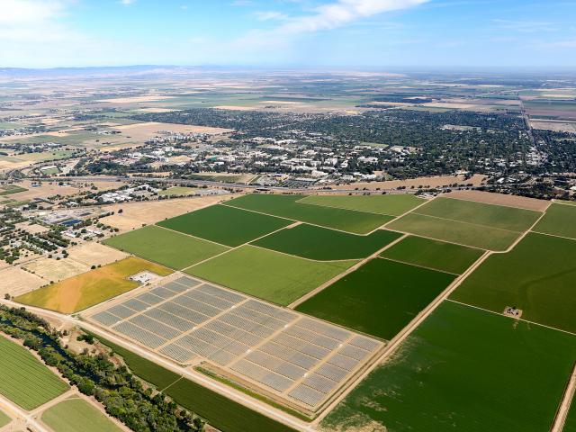 Aerial photo taken of the South Campus Large Solar Power Plant, August 2015, looking northwest with the Davis campus in the background 