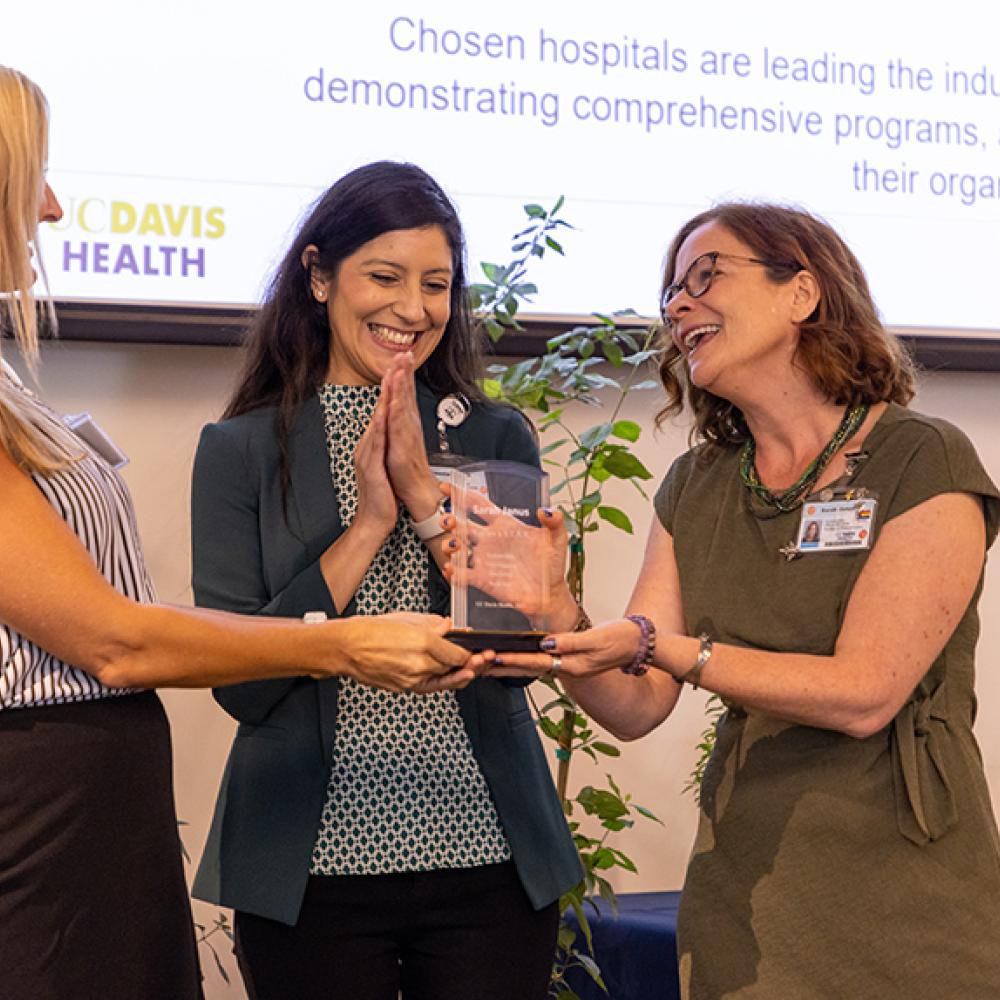 Person recieves an award at a UC Davis Health Sustainability event