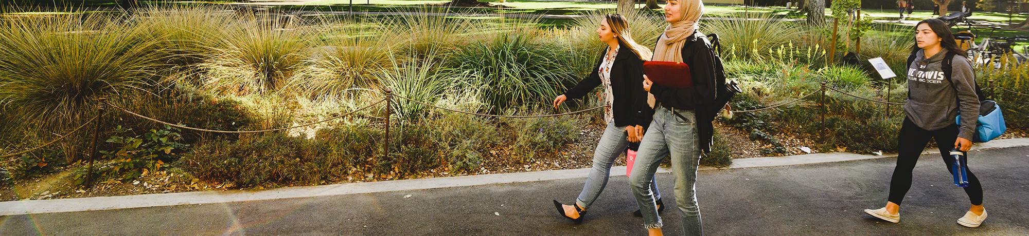 diverse group of students walking around campus uc davis