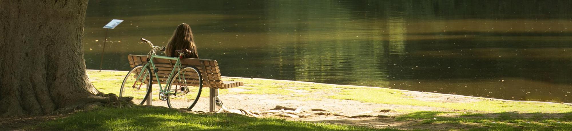 Student on bench by Spafford Lake