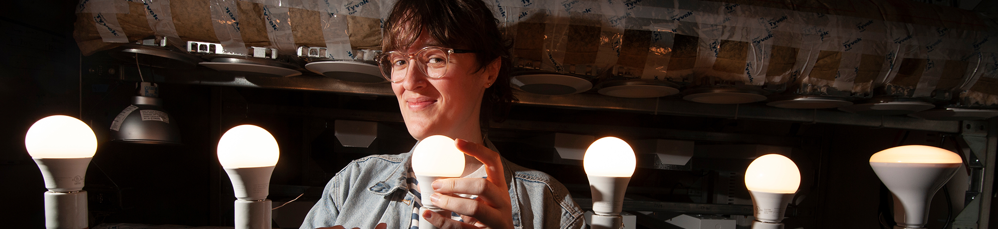 ca lighting technology staff member standing with led light